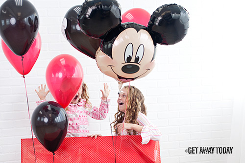 Girls opening We're going to Disneyland Mickey balloon surprise